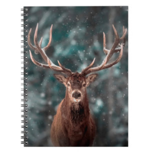 Noble deer male in winter snow forest. Artistic wi Notebook