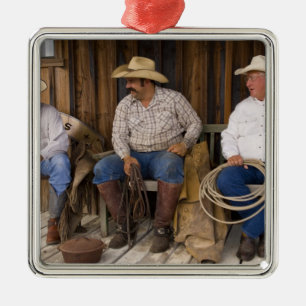 North America, USA. Cowboys relaxing and Metal Tree Decoration