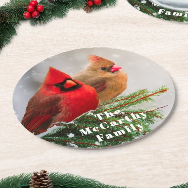 Northern Cardinals in Pine Tree Family Name Round Paper Coaster (Rustic paper Christmas party coasters feature a cardinal pair and custom family name text.)