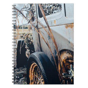 Notebook with photograph of abandoned vintage car