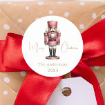 Nutcracker pink white simple Christmas Classic Round Sticker<br><div class="desc">White background,  and a pink nutcracker.  Personalise and add a name and year. Text: Merry Christmas</div>