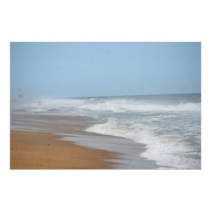 Ocean waves crashing on the beach by lighthouse poster