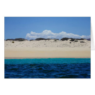 Ocean Waves On Sandy Beach Under Blue Sky