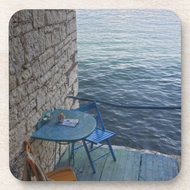 Oceanside seating for two at tiny outdoor cafe, coaster (Front)