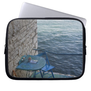 Oceanside seating for two at tiny outdoor cafe, laptop sleeve