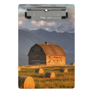 Old barn framed by hay bales and dramatic mini clipboard