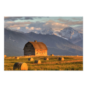 Old barn framed by hay bales and dramatic photo print