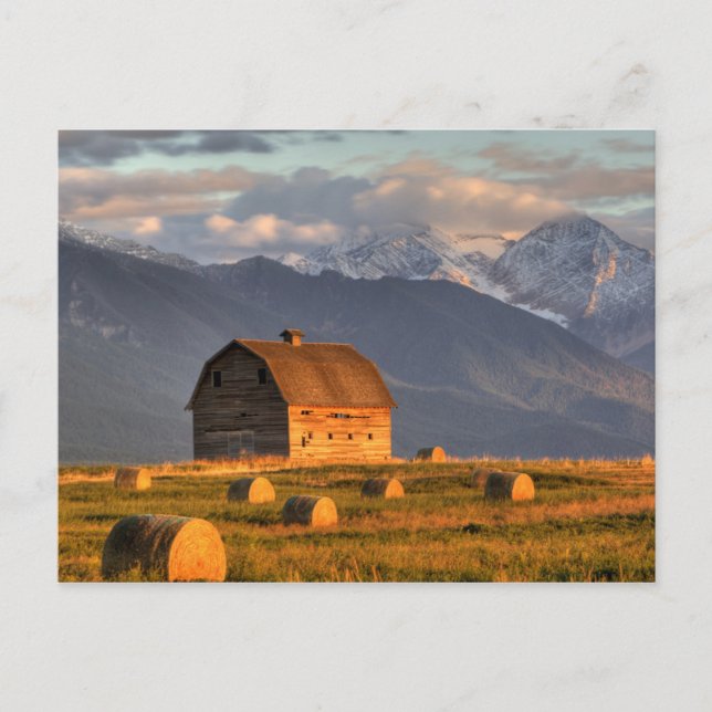 Old barn framed by hay bales and dramatic postcard (Front)