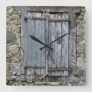 Old blue painted wood shutters square wall clock