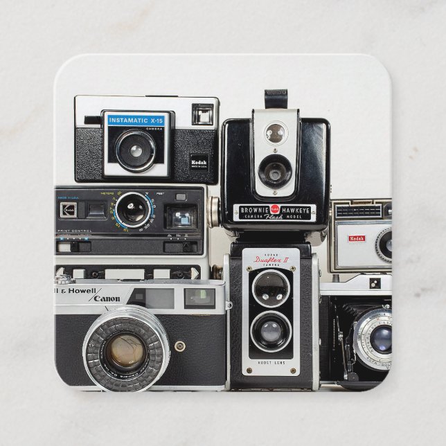 old camera collection stacked on white square business card (Front)