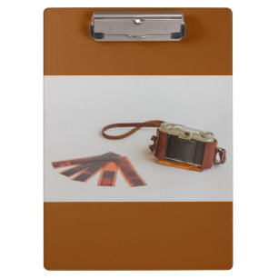 old camera with negative on clipboard