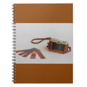 old camera with negative on   photo notebook