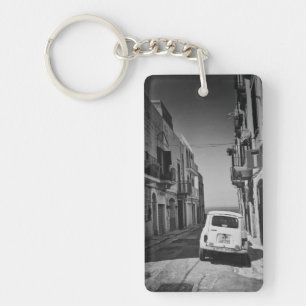 Old car in a street in Italy with sea Key Ring