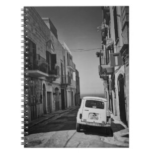 Old car in a street in Italy with sea Notebook
