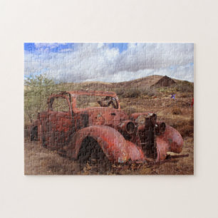 Old Car Rusting In Desert Landscape Jigsaw Puzzle