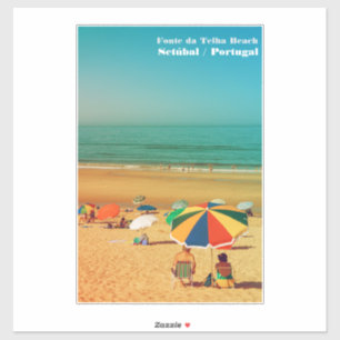 Old couple under beach umbrella in Fonte da Telha.