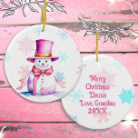 Old-Fashioned Christmas Snowman in Pink  Ceramic Ornament<br><div class="desc">Pretty personalised Christmas ornament with a cute retro snowman in a pink hat surrounded by falling pink and blue snowflakes. The back can be personalised with a custom message.</div>
