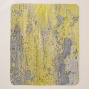 Old gray concrete wall with peeling yellow paint. sherpa blanket