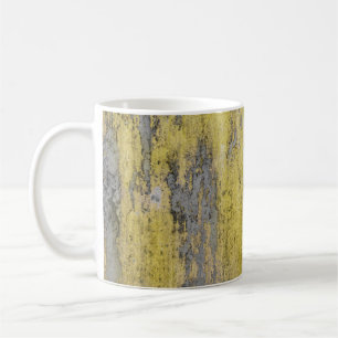 Old grey concrete wall with peeling yellow paint. coffee mug