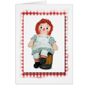 old rag doll on wooden keg