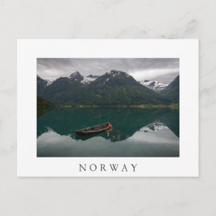 Old rowboat and mountain in Norway white postcard