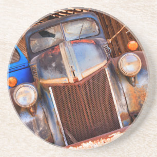 Old rusty truck on a farm coaster
