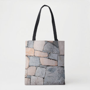 Old stone wall of ancient castle. abstract,ancient tote bag