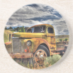 Old truck abandoned in field coaster