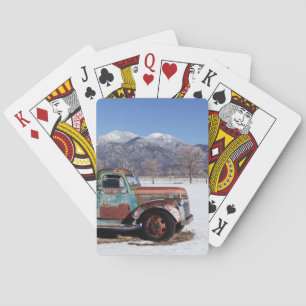 Old truck sitting in the field playing cards