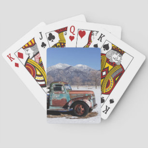 Old truck sitting in the field playing cards