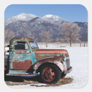 Old truck sitting in the field square sticker