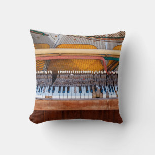 Old vintage piano with the lid off. A dilapidated Cushion