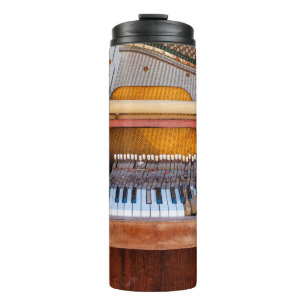 Old vintage piano with the lid off. A dilapidated  Thermal Tumbler