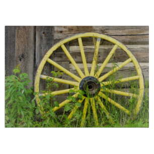 Old wagon wheel in historic old gold town cutting board