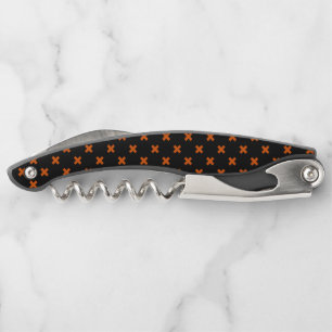Orange cross stitches on black corkscrew