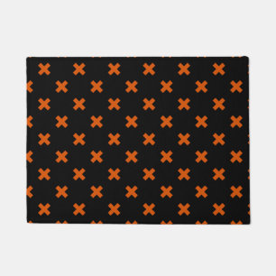 Orange cross stitches on black doormat