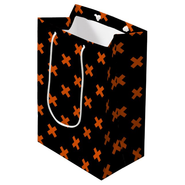 Orange cross stitches on black medium gift bag (Front Angled)