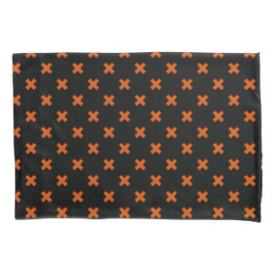 Orange cross stitches on black pillowcase