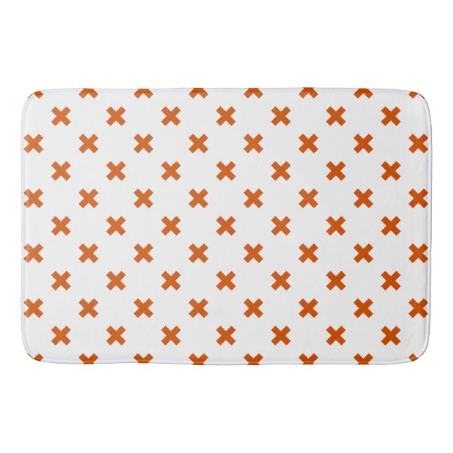 Orange cross stitches on white bath mat (Front)