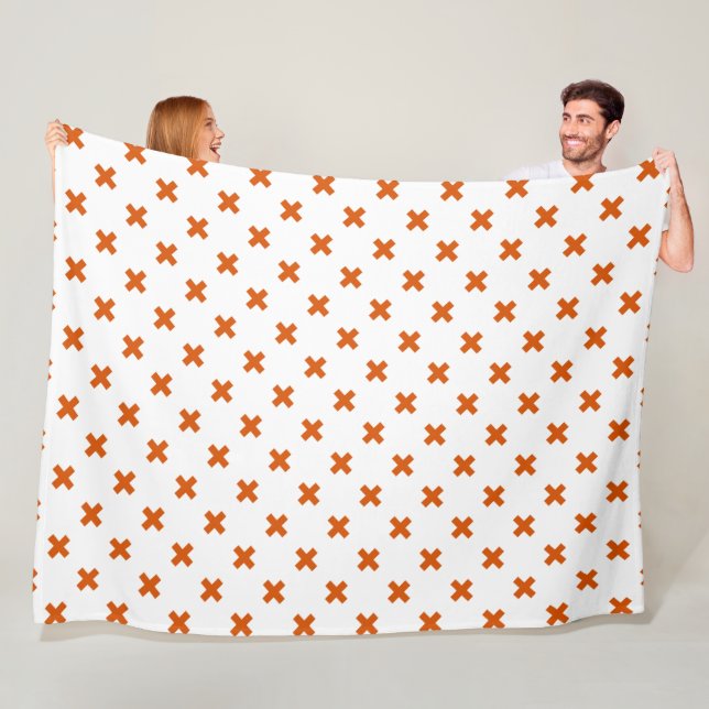 Orange cross stitches on white fleece blanket (In Situ)