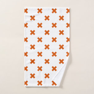 Orange cross stitches on white hand towel