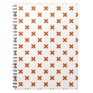 Orange cross stitches on white notebook