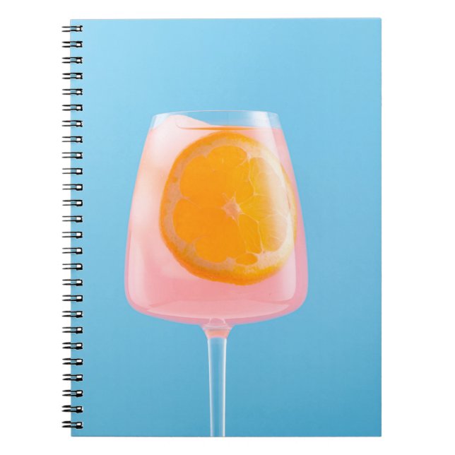 Orange juice in clear drinking glass notebook (Front)