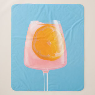 Orange juice in clear drinking glass sherpa blanket