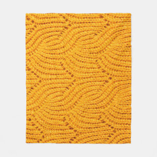 Orange knitted sweater, textured background. fleece blanket