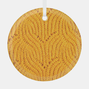 Orange knitted sweater, textured background. glass tree decoration