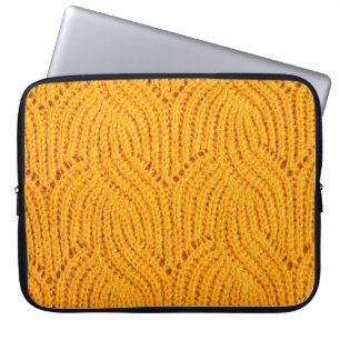Orange knitted sweater, textured background. laptop sleeve