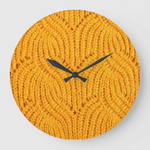 Orange knitted sweater, textured background. large clock