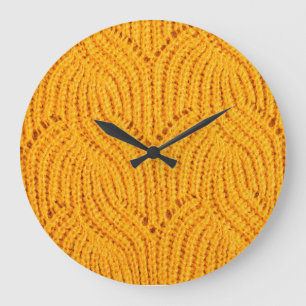 Orange knitted sweater, textured background. large clock