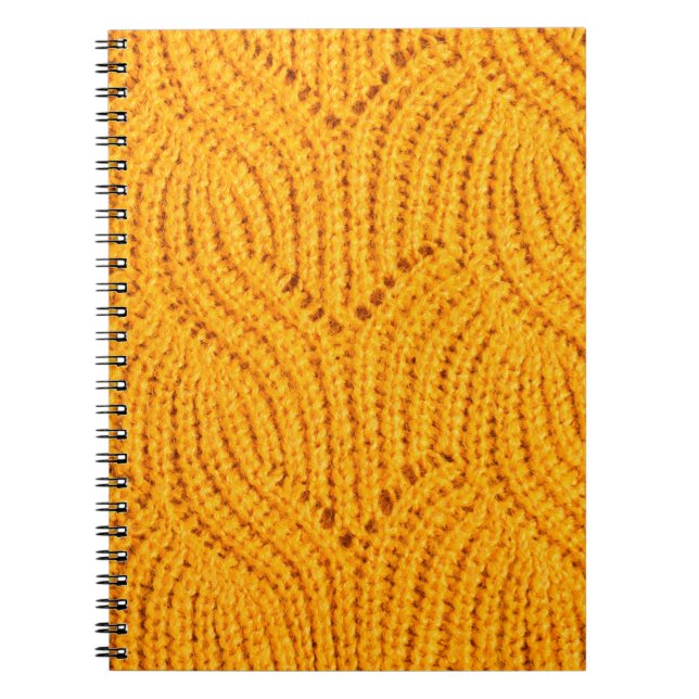 Orange knitted sweater, textured background. notebook (Front)